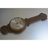 An Edwardian oak carved banjo style wall barometer, retailed by F. Robson & Co., Newcastle upon