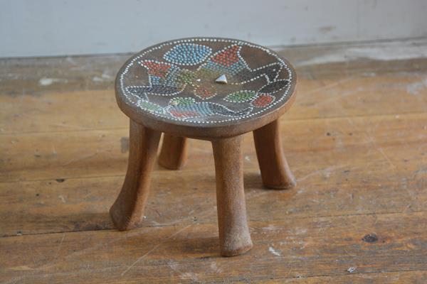 A Nigerian hardwood carved stool with inset beaded top (h.18cm x 21cm)