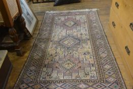 A Sumac flatwoven Nomadic rug, the central rectangle with three stylised diamond medallions enclosed