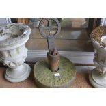 A carved sandstone turning wheel complete with cast iron pillar and clutch for soft ground key (