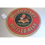 A metal stamped Budwieser Bottled Beer enamelled sign (d.51cm)