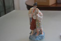 A Russian porcelain figure group, dressed in traditional costume (h.28cm)