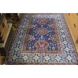 A machine woven cotton pile Caucasian style rug, the centre panel with central diamond medallion