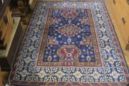 A machine woven cotton pile Caucasian style rug, the centre panel with central diamond medallion