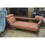 An Edwardian walnut scroll arm chaise longue style sofa with stuffover seat, raised on carved