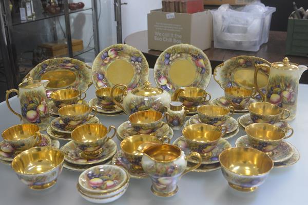 An Aynsley china gilded fifty two piece tea and coffee service with transfer printed fruit, complete