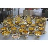 An Aynsley china gilded fifty two piece tea and coffee service with transfer printed fruit, complete