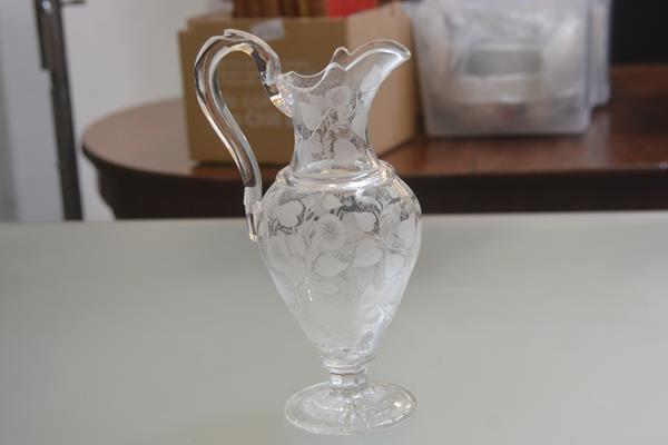 A 19thc baluster water jug with allover engraved clematis leaf and flower decoration (stress mark to