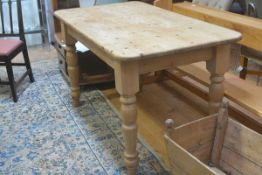 A 19thc style stripped pine kitchen dining table, the rectangular top with rounded angles and