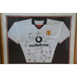 A Manchester United Alex Ferguson signed and team signed white Vodafone shirt in gilt glazed