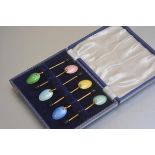 A set of six gilt metal guilloche enamelled bean handled coffee spoons in original fitted case (
