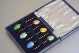 A set of six gilt metal guilloche enamelled bean handled coffee spoons in original fitted case (