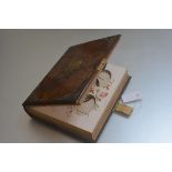 A Victorian walnut brass mounted photograph album with decorated floral card pages, complete with