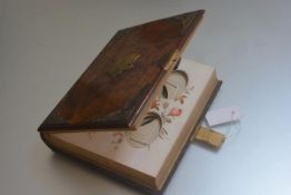 A Victorian walnut brass mounted photograph album with decorated floral card pages, complete with