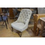 A Victorian nursing chair with upholstered button back and side supports and seat, in fawn plush,