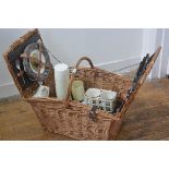 A wicker picnic hamper by Brexton, c.1960 complete with teak handled knives, plates, cups, mugs