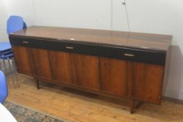 A Beresford & Hicks 1960s rosewood longjohn style sideboard, fitted three vinyl fronted drawers