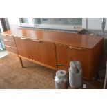 A McIntosh & Co., Ltd., Kirkcaldy, teak longjohn style sideboard, the rectangular top with moulded