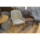 A pair of 1930s leather upholstered tub chairs on oak square tapered splay supports united by X
