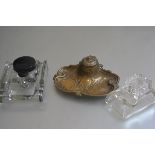 A French style brass desk inkstand with hinged top enclosing an original ceramic liner, with olive