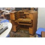 A 1950s/60s compactum home office, the twin opening panel doors enclosing a filing and shelf lined