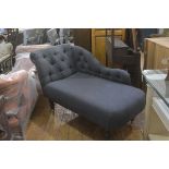 A neat modern chaise longue with upholstered button back and scroll arm, in grey felted wool, raised