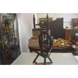 A 19thc stained oak spinning wheel complete with foot pedal on tripod turned tapered support (some