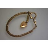 A Victorian gilt metal guard chain with swivel and plated paste set heart (18.5cm)