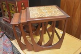 A G Plan nest of three coffee tables, the large table with inset tiled panel, the two smaller with