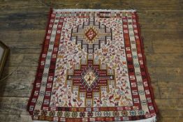 A Sumac Uzbekistan woven rug, the centre panel with twin stylised medallions with birds enclosed