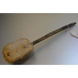 A Sudanese stringed instrument, the bow from a turtle shell on a carved wooden stem (lacking