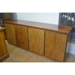 A Skouby Danish rosewood sideboard c.1975/80, the rectangular moulded top above four panel doors,