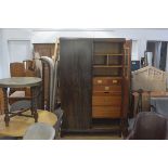 A 1930s figured and inlaid walnut two door wardrobe with moulded cornice, with fully fitted