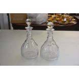 A pair of 19thc Irish style lead crystal thumb cut triple ring neck decanters, with later faceted