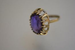 A 9ct gold ring mounted purple stone, in raised claw setting (J) (3.55g)