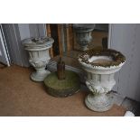 A pair of composition stone urns with fluted and scrolling bowls, raised on circular bases (h.52cm