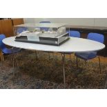A modern oval white laminated top dining table raised on chrome tubular supports (h.73cm x 220cm x