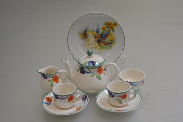 An ivory ware handpainted doll's seven piece teaset and an English china painted plate (a lot) (