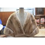 A lady's ranch mink opera shrug, with satin lining and single pocket (38cm x 43cm)