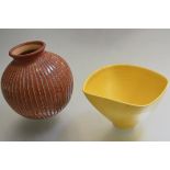 Roger Carbo, a circular incised pottery vase with terracotta glaze and a yellow Studio Pottery