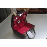 A lady's Cheney black patent vinyl vanity case with pink lined interior, complete with original