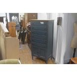 A distressed blue painted pine tallboy chest, fitted six long drawers above a pair of panel doors,