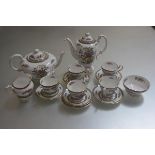 A Paragon Tree of Kashmir coffee service comprising five cups, six saucers, milk jug, sugar basin,