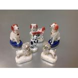 A group of 19th century Staffordshire dog and cat models comprising: a pair of seated spaniels, each