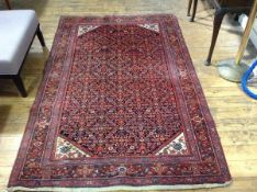 A North Persian rug, the centre triangle with diamond shaped panel with repeating all over