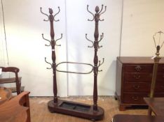 An unusual late Victorian mahogany double hall stand, the paired baluster-turned columns each with