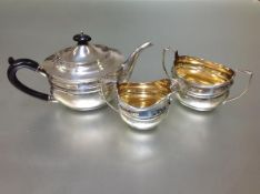 A George V silver three-piece tea service, Robert Stewart, London 1913, in the Regency taste, each