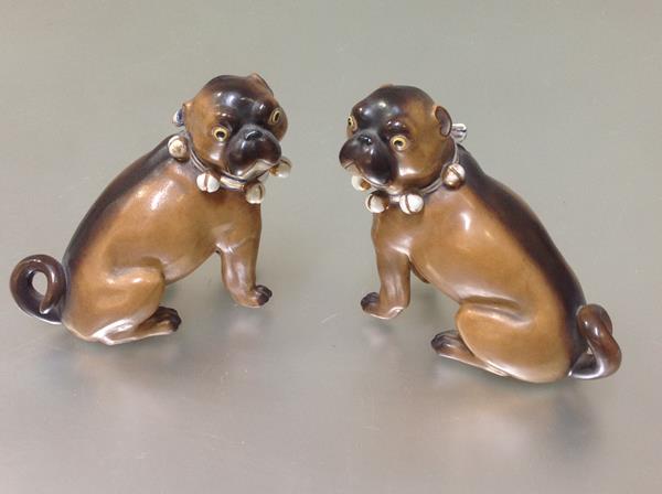 A pair of late 19th century porcelain models of seated pugs, possibly Conta & Boehme, after