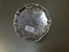 A George III silver waiter, Ebenezer Coker, London 1769, circular, with gadrooned scalloped rim, the