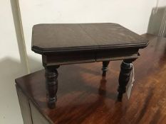 A late Victorian miniature oak draw leaf dining table, c. 1900, the rectangular moulded top with